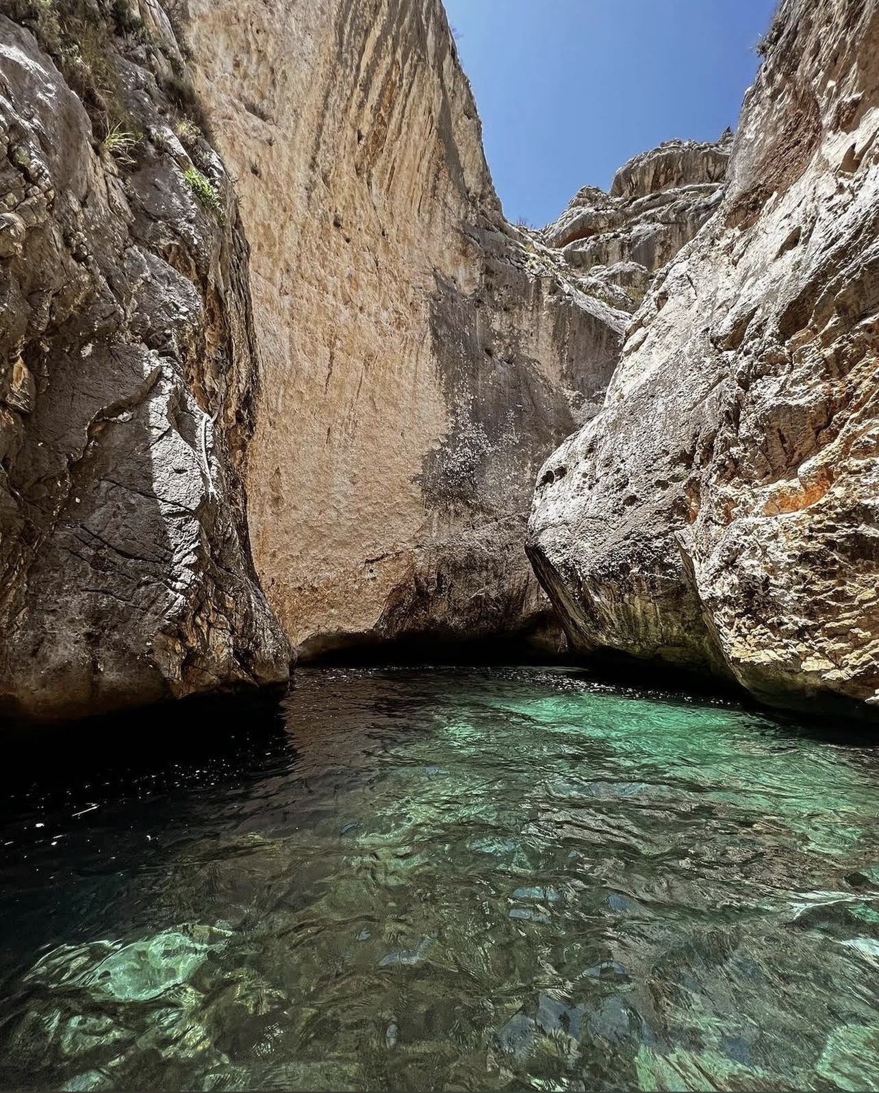 Emerald water inside the narrow sea canyon