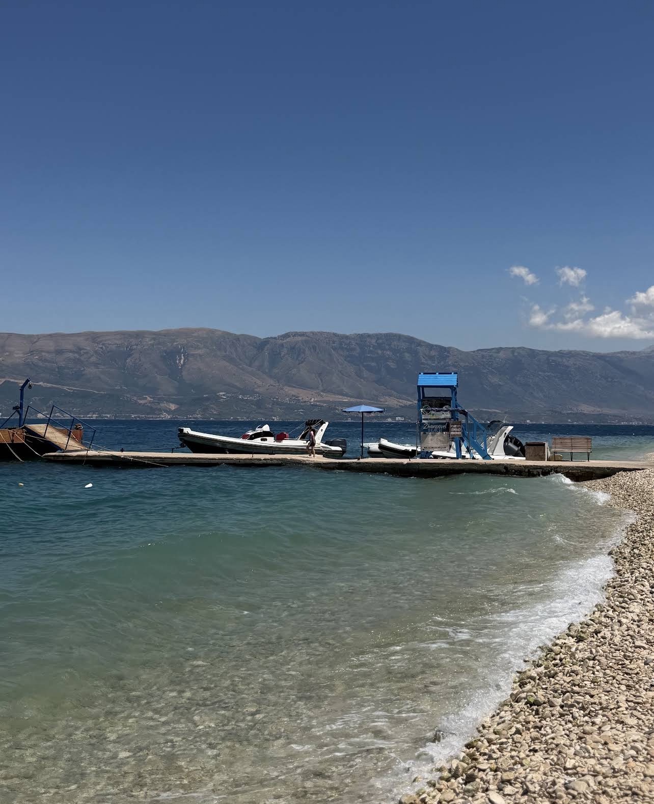 Boats and pier on the Orikum shoreline